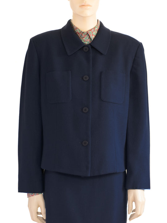   Front view of the model wearing a vintage dark blue wool skirt suit by Chaus.