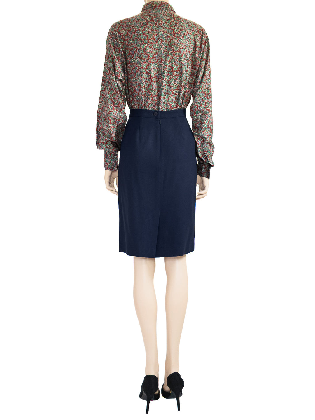 This is a back view of the model wearing a Chaus vintage dark blue wool skirt as part of a two-piece 1980s suit. 