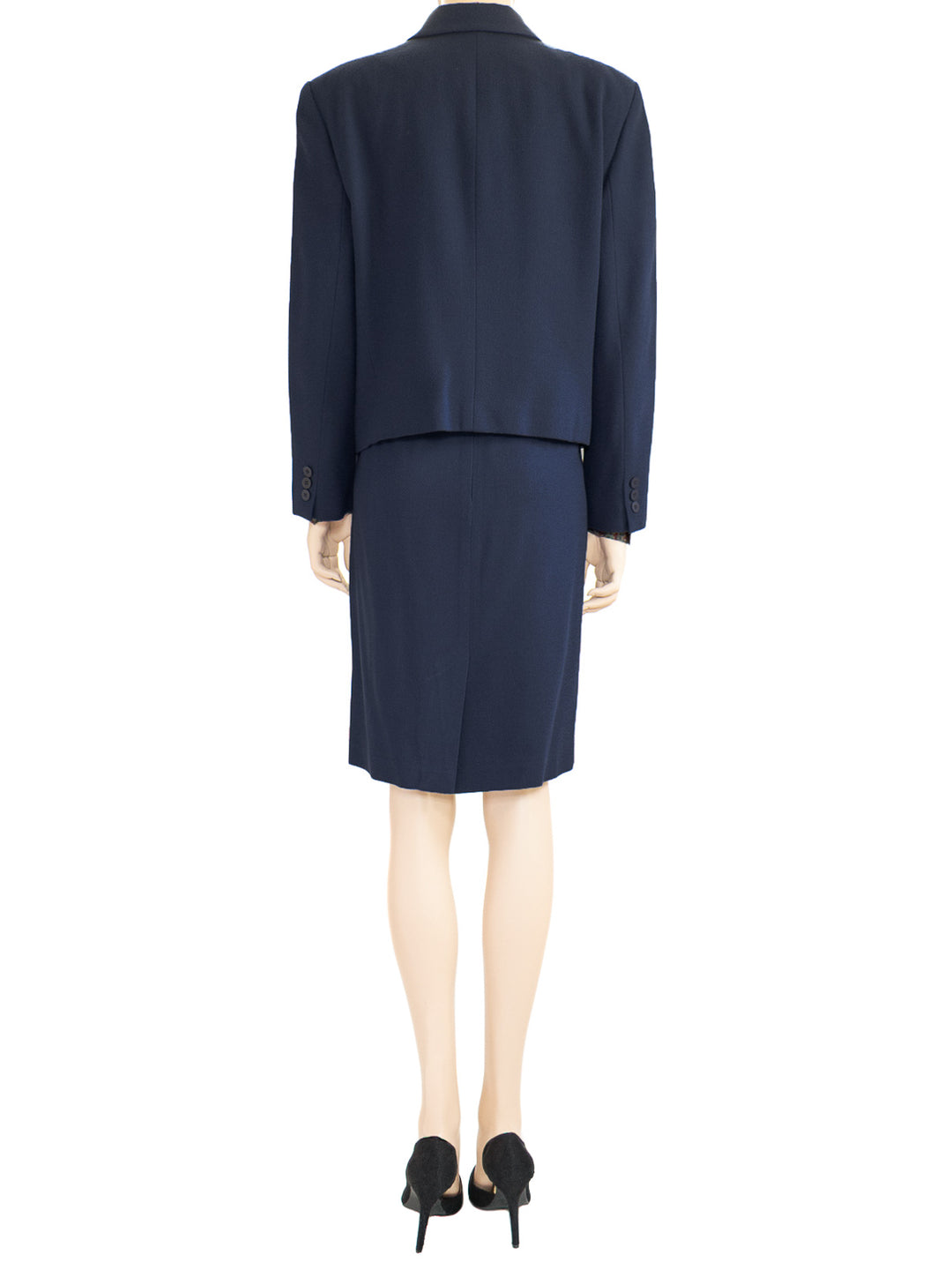 Chaus's vintage 80s dark blue two-piece wool skirt suit from the 1980s. Padded shoulders: The skirt has a back-centered zipper, a button, and a kick pleat.   
