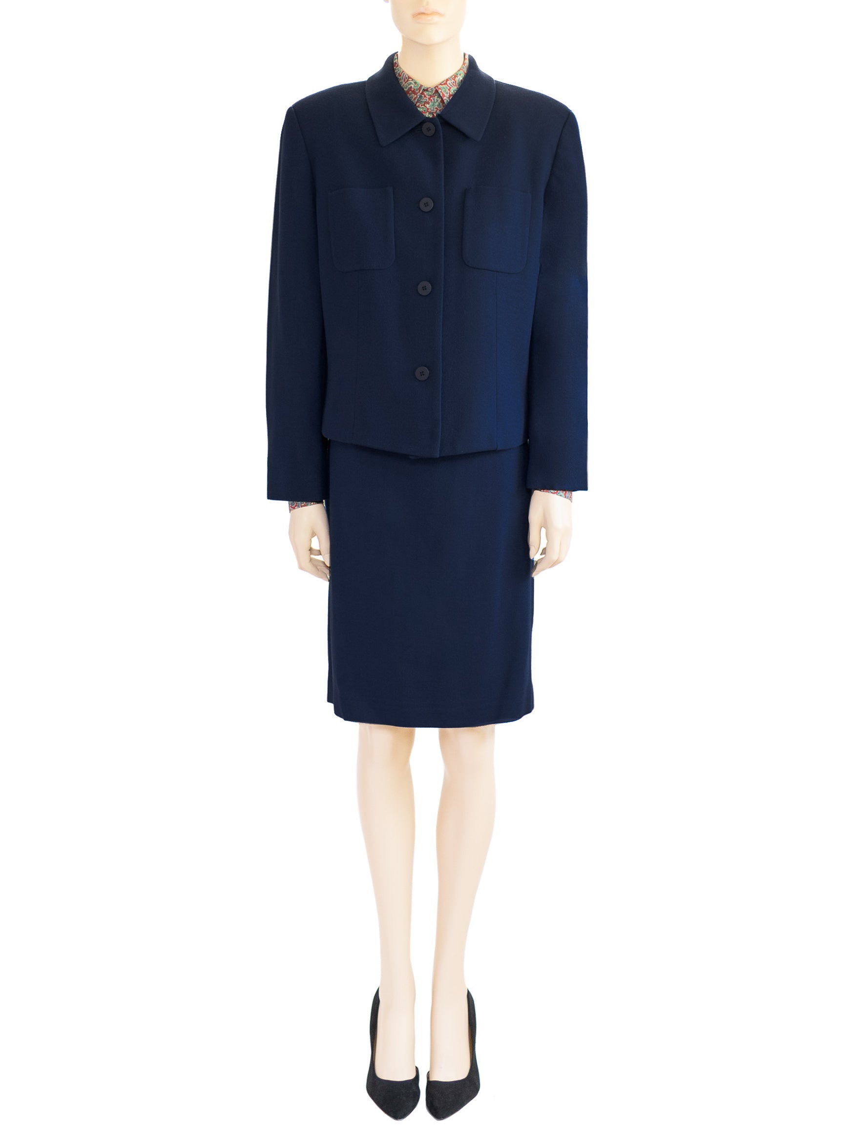 The model wears a Chaus Dark Blue two-piece wool skirt and a red paisley blouse. Boxy style jacket, straight skirt. Sz 12.