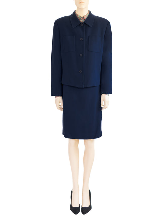The model wears a Chaus Dark Blue two-piece wool skirt and a red paisley blouse. Boxy style jacket, straight skirt. Sz 12.