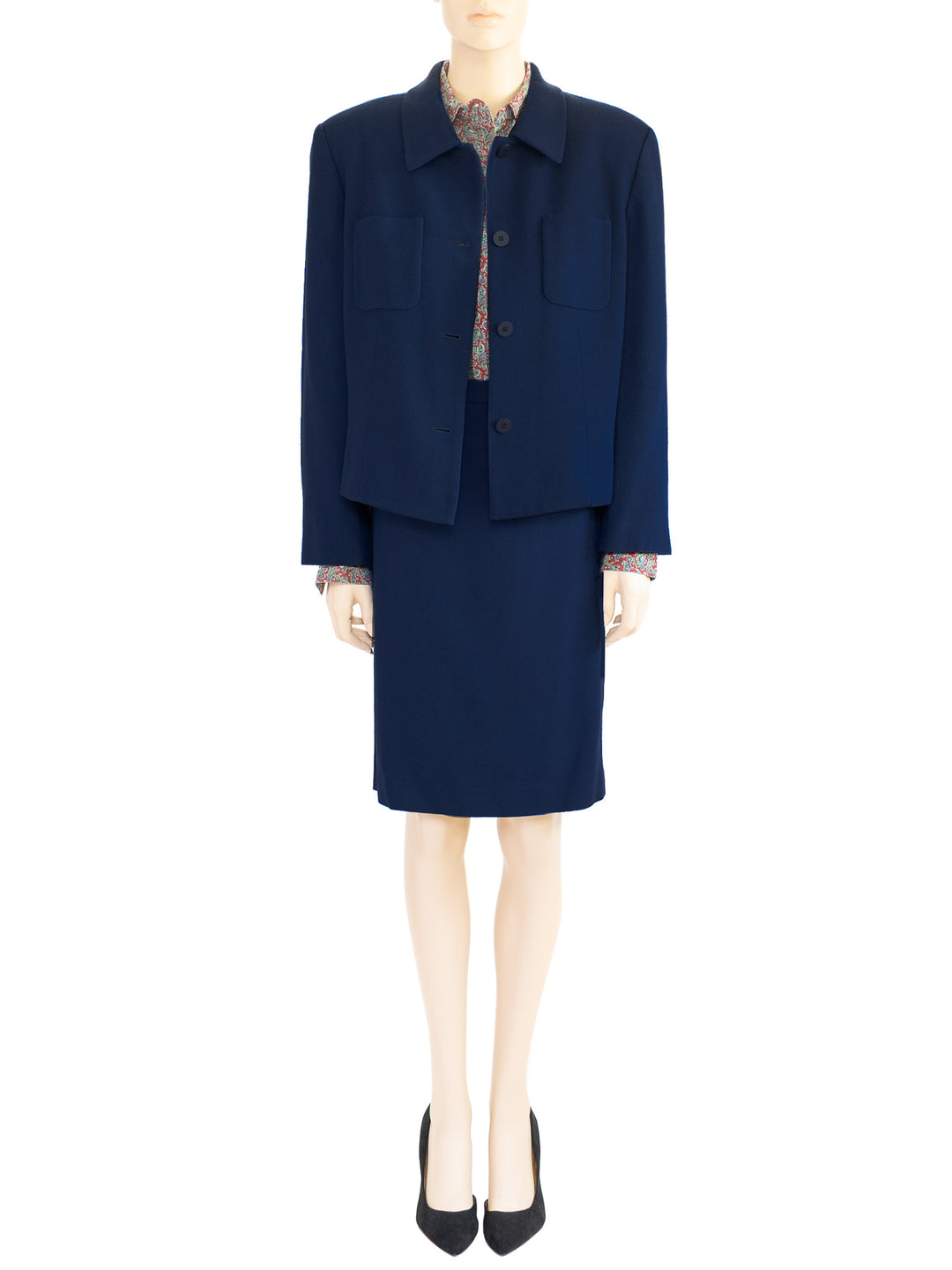 The model wears a Chaus dark blue two-piece wool skirt suit and red paisley top. The boxy-style jacket is shown open. Sz 12. 